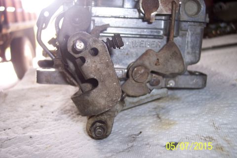 1973 Ford F-250 - Close-up view of a Weber carburetor's linkage mechanism and stamped branding.