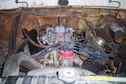 1973 Ford F-250 - Close-up view of an Edelbrock carburetor and associated engine parts, showing wiring and hoses.