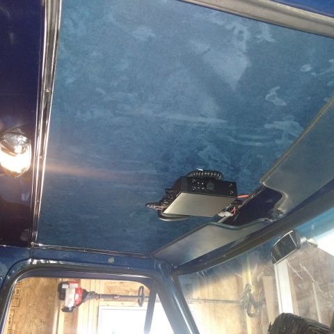 1978 Ford Bronco - Interior view of a vehicle's blue headliner with a CB radio installed overhead.