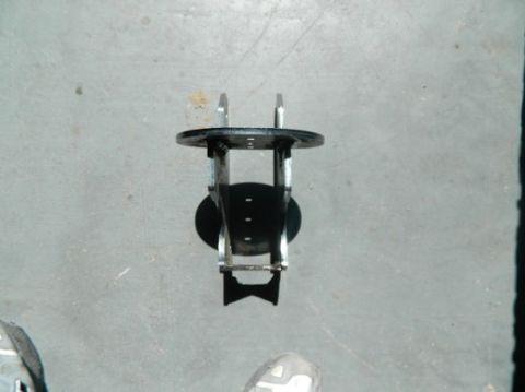 1979 Ford Bronco - A single vehicle axle part is shown against a concrete background.