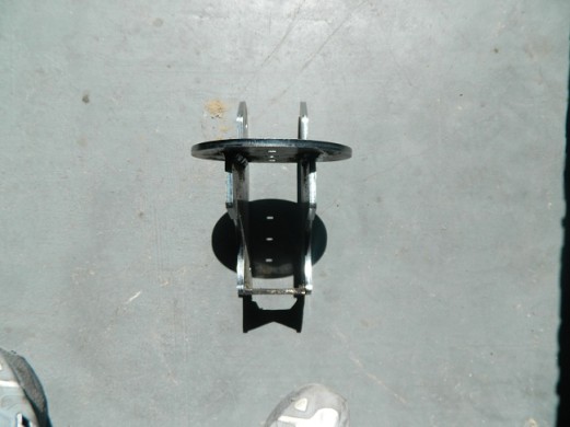Close-up of a vehicle axle component on a concrete floor