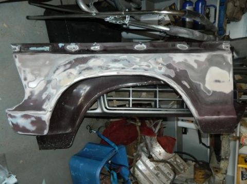 1979 Ford Bronco - A Ford Bronco rear quarter panel is shown with primer and body filler, ready for paint.