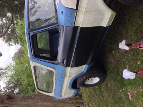 1979 Ford Bronco - A weathered 1978 Ford Bronco, painted blue and white, is parked outdoors on a grassy area.