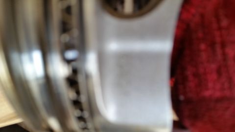 1995 Ford Bronco - Close-up interior shot of a vehicle, showing a red cloth and a portion of the wheel assembly.