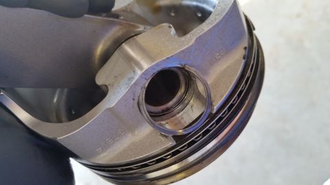 1995 Ford Bronco - Close-up of an engine piston, showing part numbers and rings. Not a 1995 Ford Bronco.
