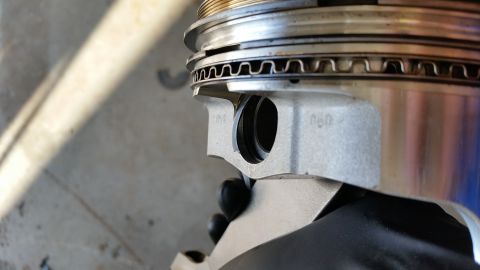 1995 Ford Bronco - A close-up view of an engine piston, showing some engraved markings.
