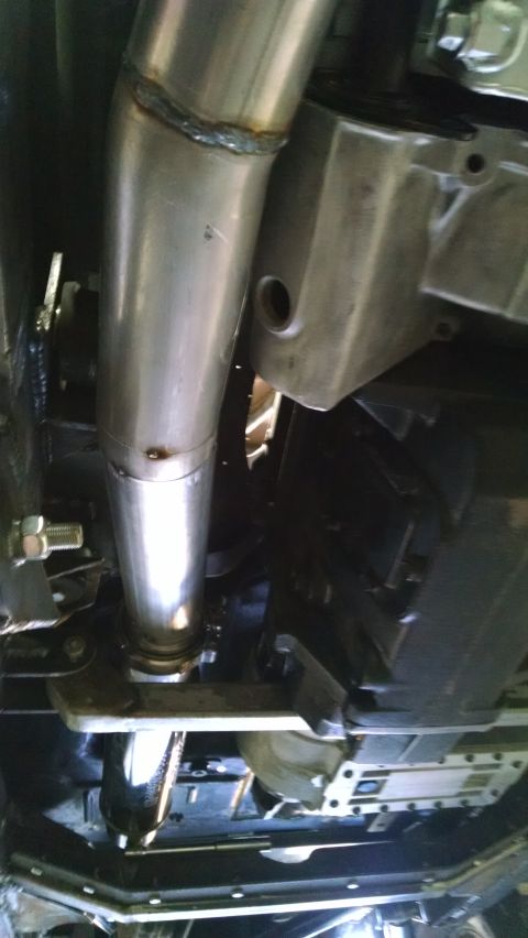 1985 Jeep CJ7 - Close-up of a vehicle's undercarriage, focusing on the exhaust system.