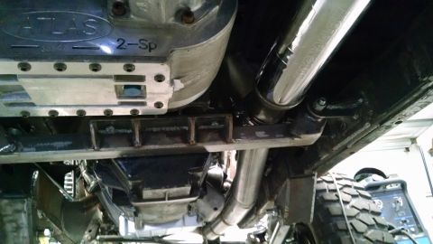 1985 Jeep CJ7 - The photo shows the undercarriage of a vehicle, focusing on the transfer case and exhaust system.