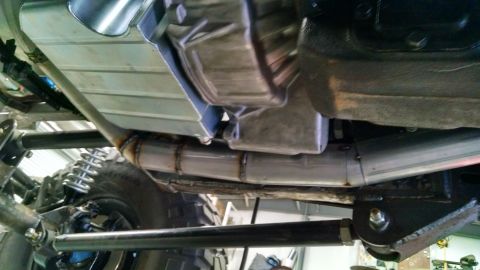 1985 Jeep CJ7 - Close-up view of the undercarriage of a vehicle, highlighting the exhaust system and suspension components.