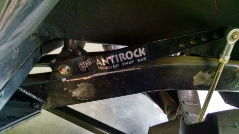 1985 Jeep CJ7 - Close-up view of an Antirock off-road sway bar attached to a vehicle's undercarriage.