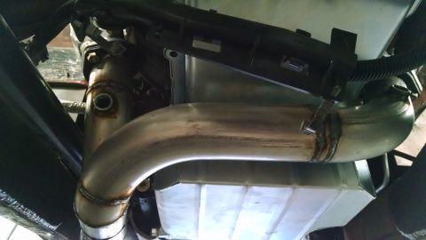 1985 Jeep CJ7 - Underside view of a vehicle's exhaust pipe and transmission pan.