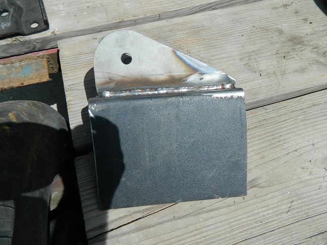 Custom axle bracket with a triangular mounting plate and a rectangular base