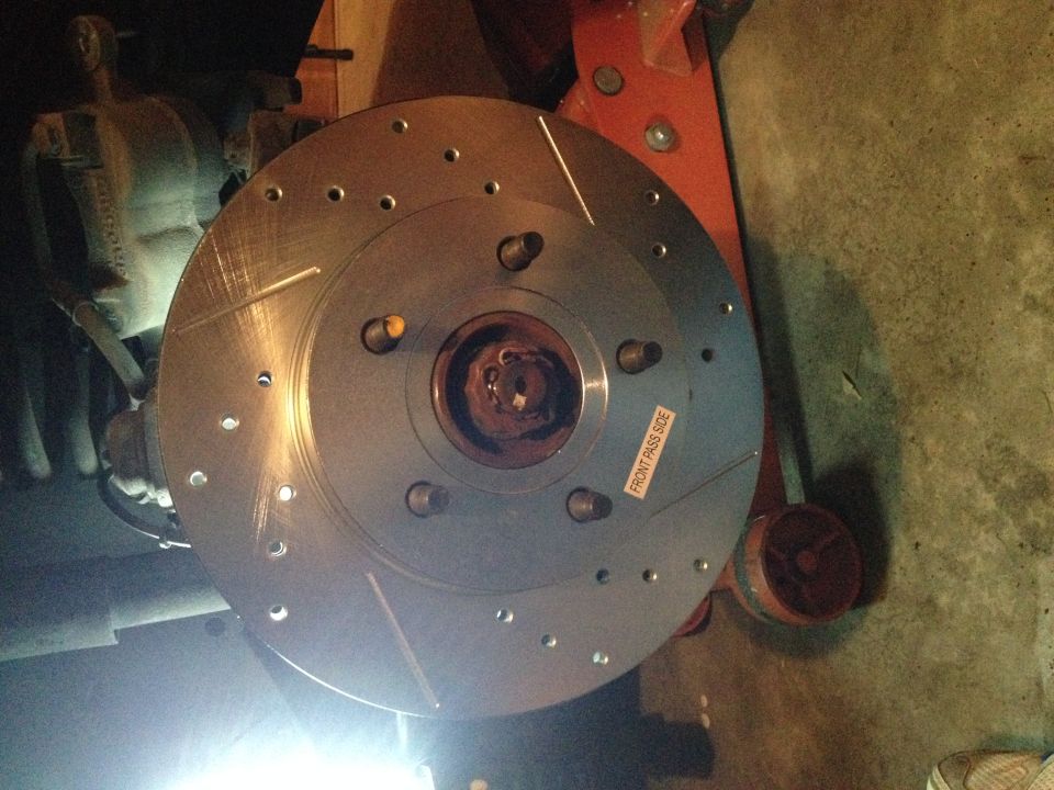 Slotted brake rotor with 'FRONT PASS SIDE' sticker