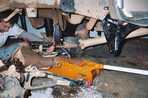 1988 Ford Bronco - Undercarriage work in progress, showing suspension and drivetrain components.