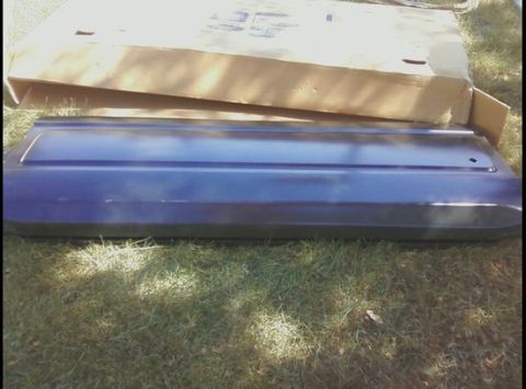 1979 Ford Bronco - A car door panel is shown on the grass next to a cardboard box.