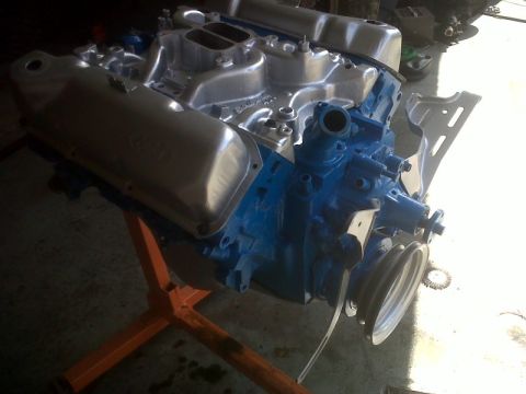 1979 Ford Bronco - A V8 engine, painted blue with aluminum components, is mounted on an orange engine stand.