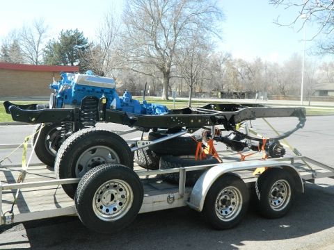 1979 Ford Bronco - The chassis and engine of a 1979 Ford Bronco are transported on a trailer.