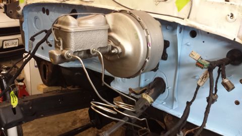 1978 Ford Bronco - Close-up of a brake booster and master cylinder assembly, showing intricate brake lines and wiring.