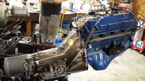 1978 Ford Bronco - Engine and transmission assembly being worked on in a garage setting.