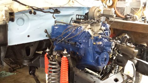 1978 Ford Bronco - Engine bay assembly with a blue Ford V8 engine and red shocks, Supermotors.net logo present.