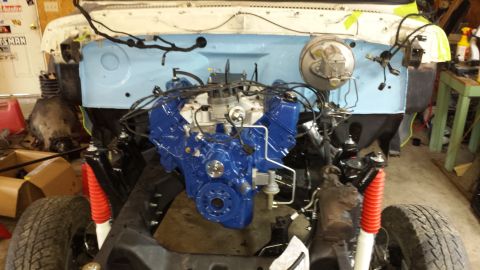 1978 Ford Bronco - Vehicle engine bay during restoration, a freshly painted blue engine and new red shock absorbers.