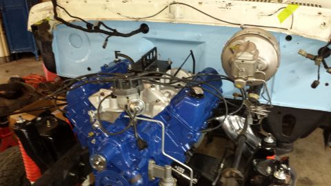 1978 Ford Bronco - Engine bay during a rebuild, a blue V8 engine and brake booster assembly.