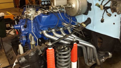 1978 Ford Bronco - Close-up of a V8 engine and suspension parts, likely undergoing restoration or repair.