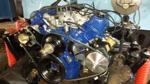 1978 Ford Bronco - Engine motor with blue valve covers and black accessory drive components.