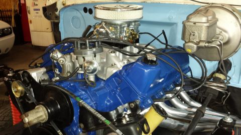 1978 Ford Bronco - Close-up of a Ford V8 engine, blue valve covers and a chrome air cleaner assembly.