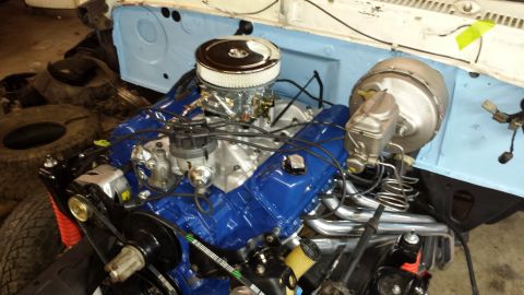 1978 Ford Bronco - The engine bay shows a V8 engine with aftermarket headers and a prominent air filter assembly.