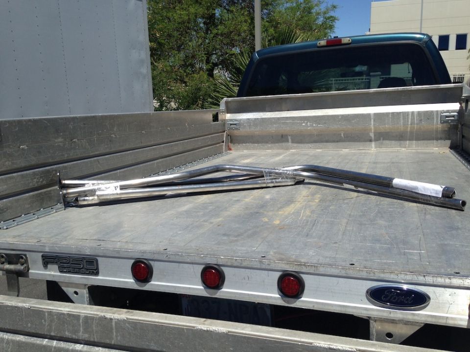 Metal roll cage tubing with red knobs and black levers