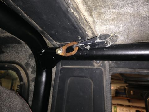 1987 Suzuki Samurai - Detail of a roll cage attachment point inside a vehicle.