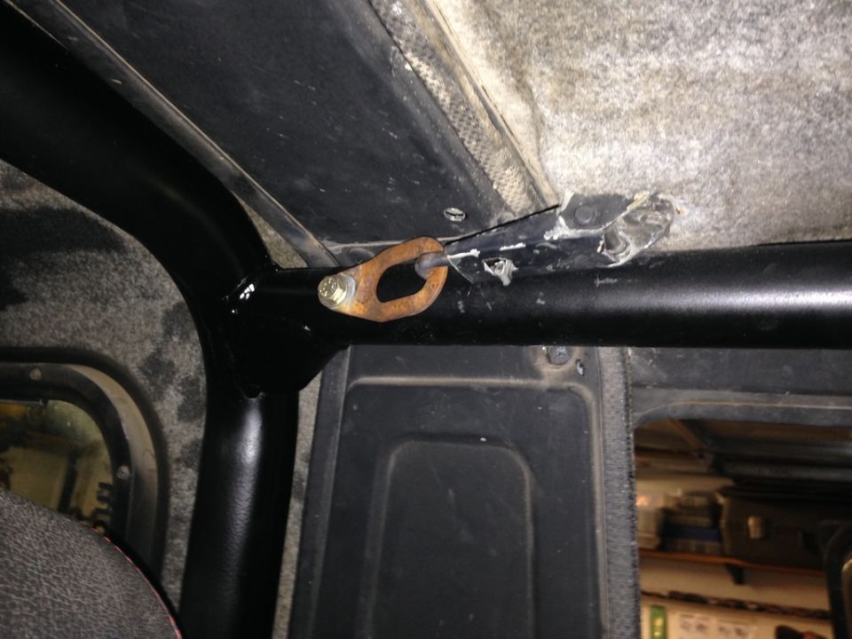 Close-up of a roll cage tube with a mounting bracket attached