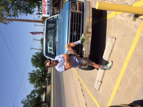 1984 Ford Bronco - A man poses in front of a blue Ford truck, which appears to be from the early 1980s.