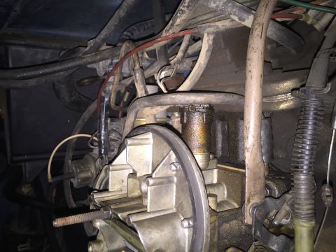 1984 Ford Bronco - Close-up view of an engine's carburetor and associated hoses, with a watermark at the bottom right.