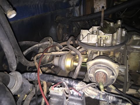 1984 Ford Bronco - Close-up view of an engine carburetor, showing the "Motorcraft" branding.