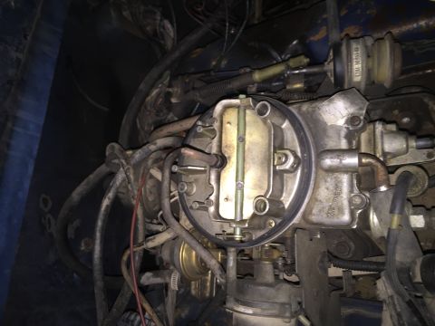 1984 Ford Bronco - A detailed view of the engine's fuel delivery system, focusing on the carburetor and associated components.