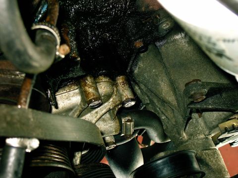 1992 Ford F-150 - Close-up view of an engine part showing significant oil accumulation and leakage.