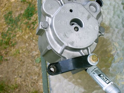 1992 Ford F-150 - A smog pump part is shown with a bracket and anti-seize lubricant.