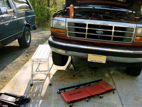 1992 Ford F-150 - The front grille and headlights of a 1992 Ford F-150 are visible, with the hood open and a New Jersey license plate attached.