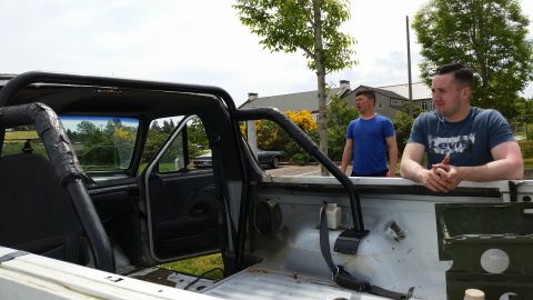1993 Ford Bronco - Interior and bed view of a 1993 Ford Bronco with two men observing.