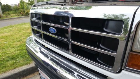 1993 Ford Bronco - Close-up of a Ford vehicle's front grille, showing chrome accents and the Ford logo.