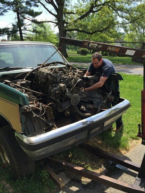 1990 Ford Bronco - Engine removal in progress on a 1990 Ford Bronco using an engine hoist.