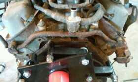 1990 Ford Bronco - Close-up view of an engine assembly, showing various hoses, wiring, and mechanical components.