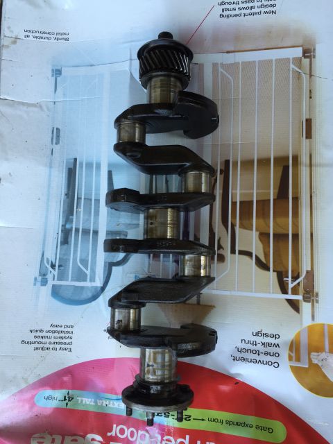 1946 Jeep Willys - A crankshaft is shown, a critical component of an internal combustion engine.