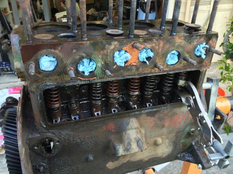 1946 Jeep Willys - Engine block with blue rags stuffed into the cylinders and valve springs exposed, undergoing some form of maintenance.