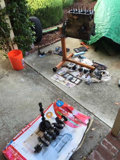1946 Jeep Willys - Engine parts laid out on a driveway for repair or assembly.