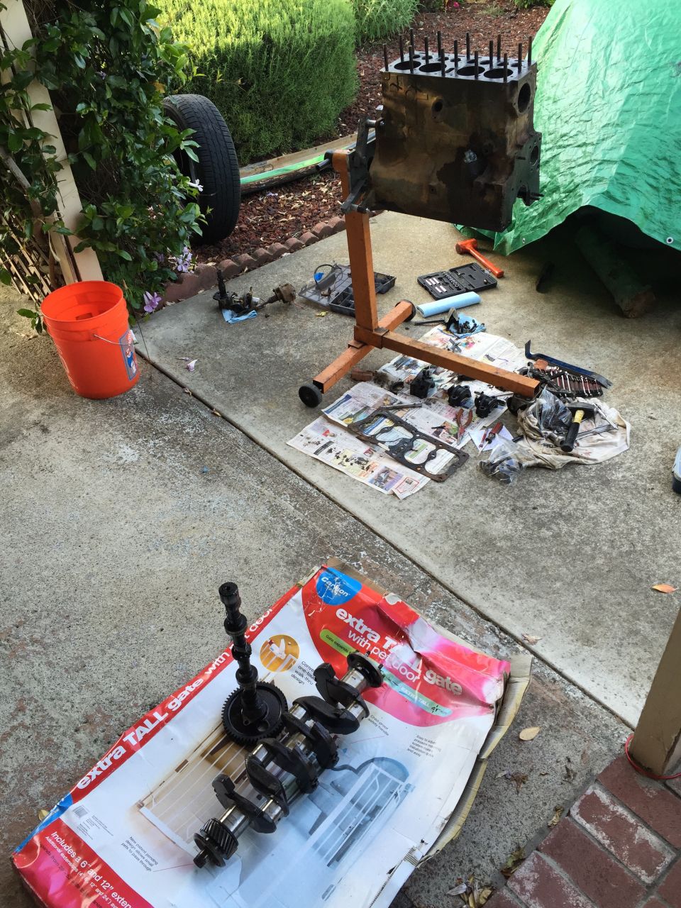 Engine block on stand with crankshaft and camshaft on box