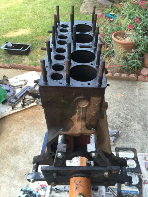 1946 Jeep Willys - An engine block is disassembled and placed on an engine stand outdoors.