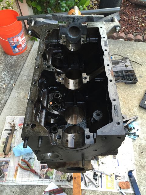 1946 Jeep Willys - Engine block disassembled and mounted on a stand, with tools scattered around.